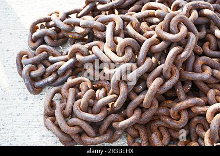 Heavy metal chains for boat on concrete ground Stock Photo