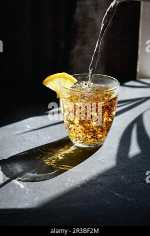 https://l450v.alamy.com/450v/2r3bf2m/boiling-water-being-poured-over-fruit-tea-2r3bf2m.jpg