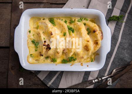 Celeriac gratin in a creamy cashew nut sauce topped with vegan cheese Stock Photo
