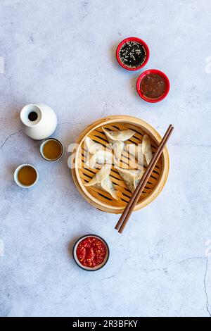 Steamed prawn dumplings with chilli oil, sambal oelek and soy Sauce Stock Photo