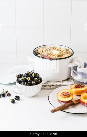 Oat porridge with butter and fresh blackberries Stock Photo