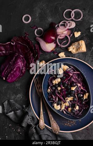 Salad with red cabbage, blueberries, blue cheese, red onion and olive oil Stock Photo