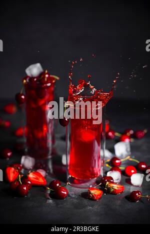 Strawberry, rhubarb and cherry drink with ice Stock Photo