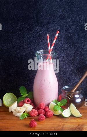 A raspberry smoothie in a glass bottle Stock Photo