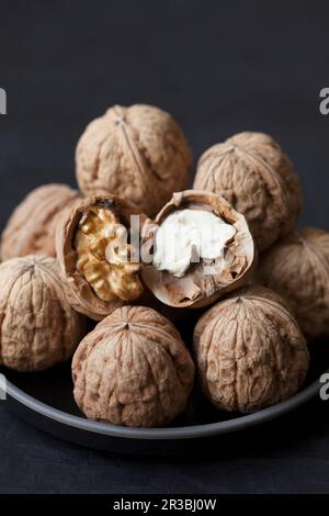 Walnuts, whole and broken open Stock Photo