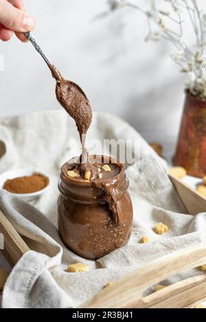 Drip of Homemade Vegan Gluten free Chocolate Hazelnut Spread with Cookies Stock Photo