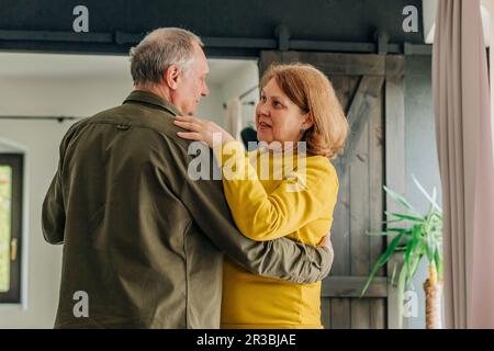 Senior couple dancing together at home Stock Photo