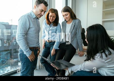 Business people working together on laptop in office Stock Photo