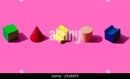 3D render of colorful toy blocks against pink background Stock Photo