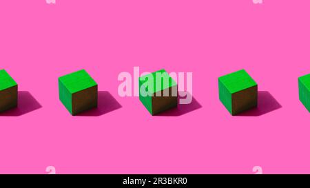 3D render of row of green cubes against pink background Stock Photo