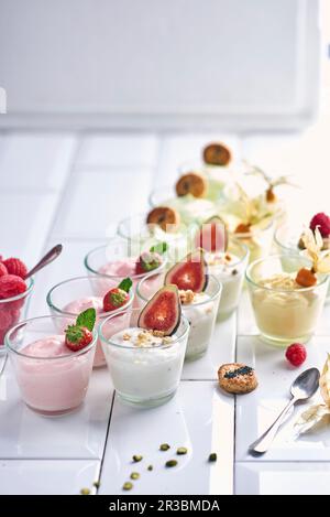 Various yoghurt desserts with fruit in small glasses Stock Photo