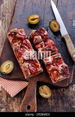 Spelled plum cake from the tin on wooden board Stock Photo
