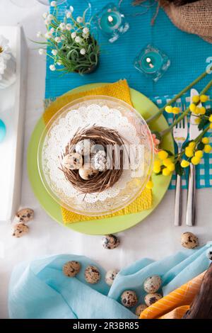 Easter table setting with quail eggs Stock Photo