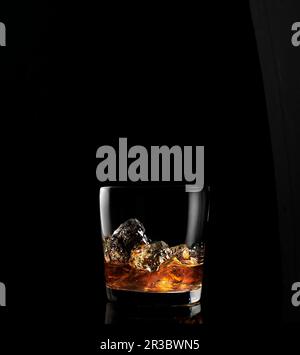 Whiskey on ice in glass Stock Photo
