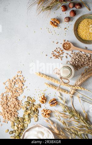 Cereals, seeds, groats, nuts, pumpkin seeds, yoghurt and milk Stock Photo