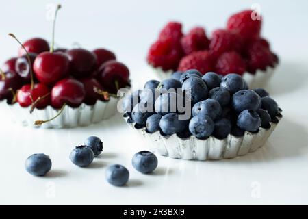 Tart cases with cherries, blueberries and raspberries Stock Photo