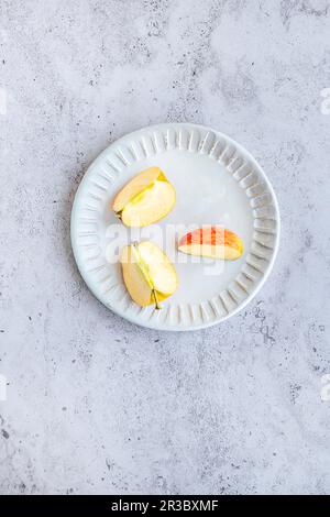 Slices of envy apples on a decorative ceramic plate Stock Photo