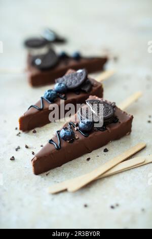 Chocolate covered cheesecake pops with cookies Stock Photo