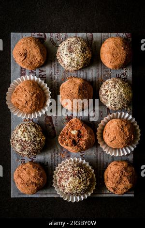 Handmade chocolate biscuit and cream liqueur truffles, rolled in cocoa powder and hazelnut crumbs Stock Photo