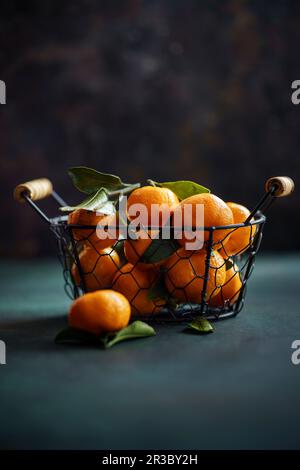 Tangerines in basket on dark Stock Photo