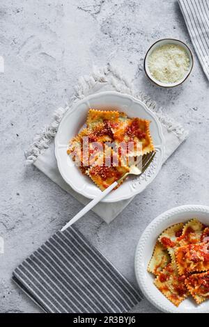 Ricotta and spinach ravioli with tomatoe sauce Stock Photo