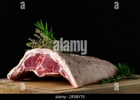 Raw rack of lamb on a wooden board Stock Photo