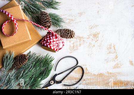 Gift boxes, ribbon and winter decoration on old wooden white table as aholiday card concept Stock Photo