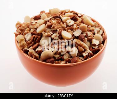 Coarse chopped mixed nuts in a bowl Stock Photo