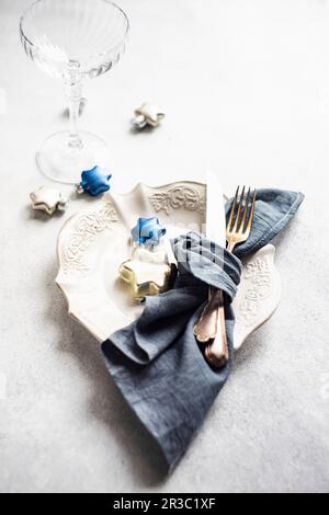 Minimalistic table setting for Christmas dinner on white concrete table Stock Photo