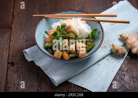 Marinated fried tofu with green beans and sesame seeds Stock Photo