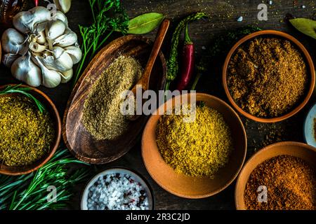 Variety of traditional georgian spices in bowls on wooden table Stock Photo