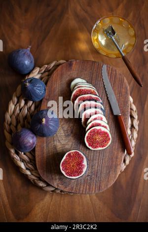 Ripe figs, whole and sliced, with honey Stock Photo