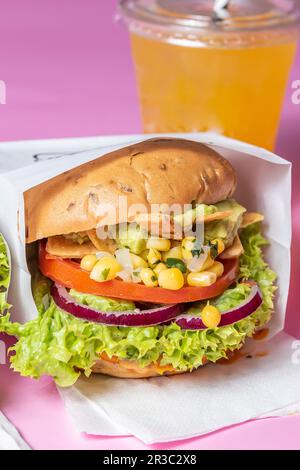 Burger with lemonade in the background Stock Photo