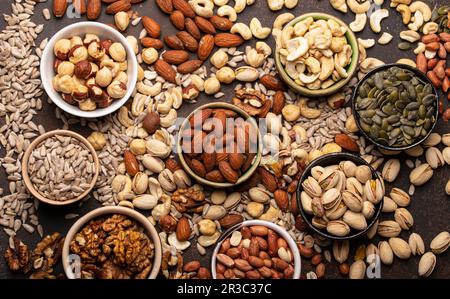 Assorted nuts and various seeds in bowls Stock Photo