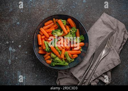 Healthy diet steamed vegetables salad with baby carrot and broccoli in bowl Stock Photo