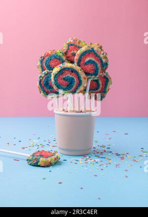 Vegan shortbread biscuits with rainbow sugar sprinkles on a stick Stock Photo