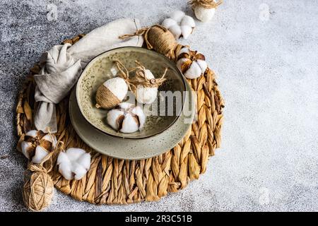 Easter festive table setting with tiny eggs and tableware on stone background Stock Photo