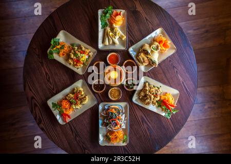 Various Thai starters on restaurant table Stock Photo