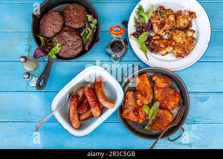 Grilled burgers, chicken, pork and sausages Stock Photo