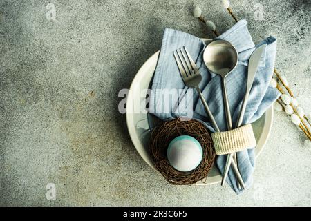 Easter dinner place setting on concrete background Stock Photo