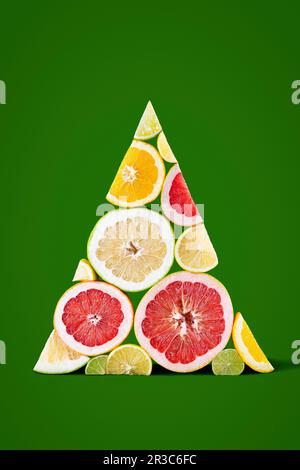 Citrus slices arranged in triangular Christmas tree shape Stock Photo