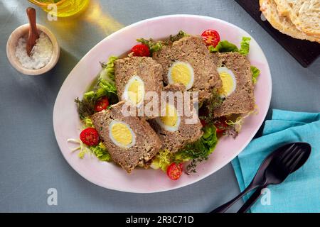 Meatloaf with egg (fake rabbit) on salad Stock Photo