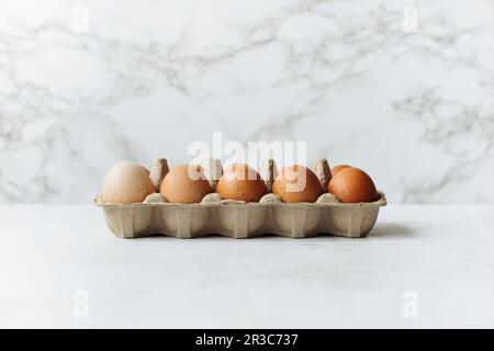 Fresh eggs in an egg box Stock Photo