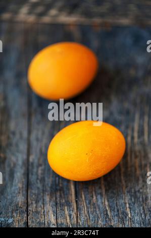 Yellow Easter eggs on a wooden background Stock Photo