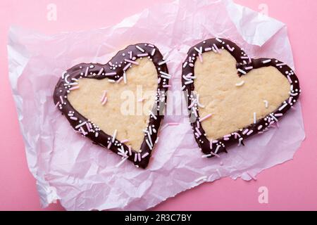 Vegan vanilla shortcrust hearts with plain icing and sprinkles Stock Photo