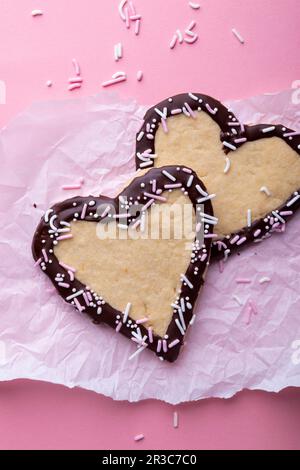 Vegan vanilla shortcrust hearts with plain icing and sprinkles Stock Photo