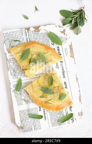 Focaccia with potatoes, sage, and rosemary Stock Photo