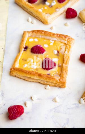Raspberry, white chocolate and custard tarts Stock Photo