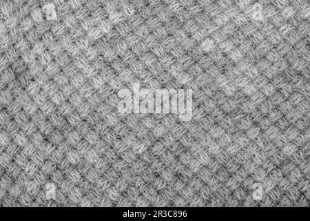 Wool sweater texture close up. Knitted jersey background with a relief pattern. Braids in machine kn Stock Photo