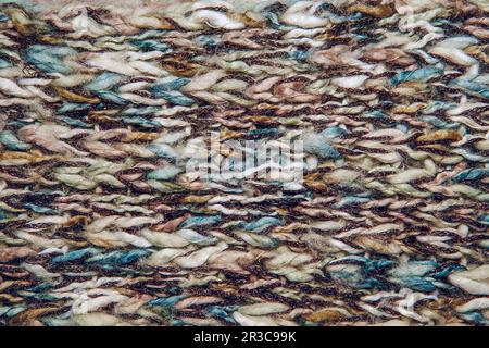 Close up on knit woolen fur texture. Color melange fluffy woven thread sweater or scarf as a backgro Stock Photo